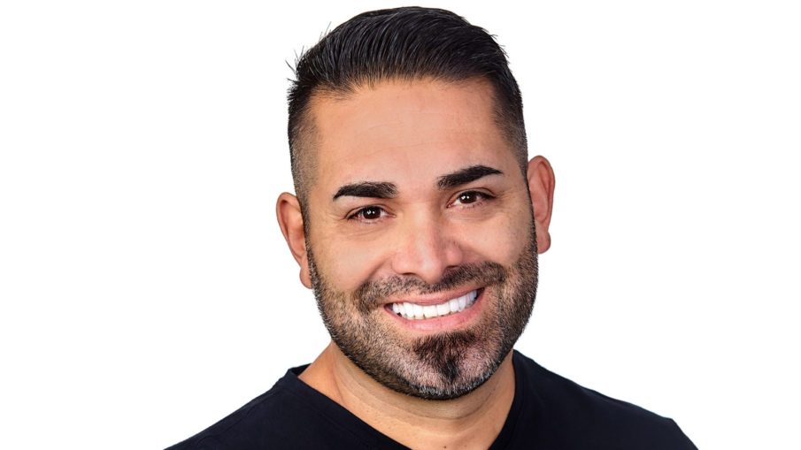 Man smiling and showing how dental veneers makes him confident about how his smile looks.